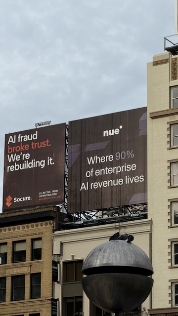 Two billboards side by side, one reading “AI fraud broke trust. We're rebuilding it.” and the other “Where 90% of enterprise AI revenue lives”.