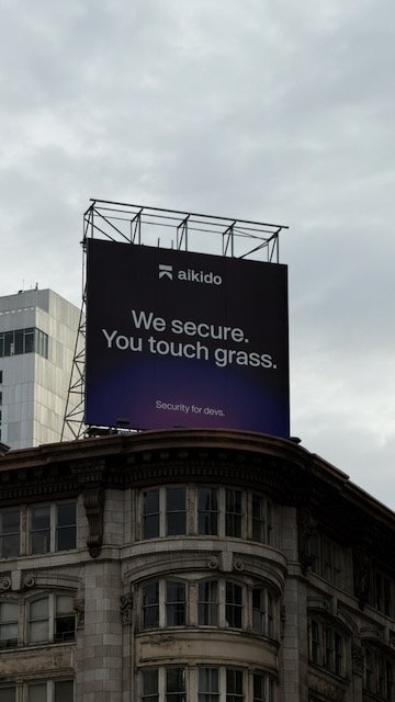 Billboard reading: “We secure. You touch grass.”